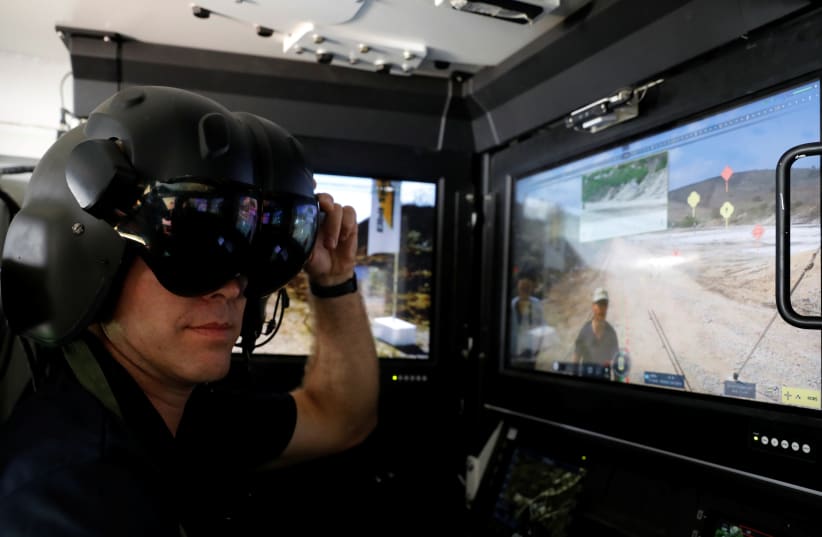 An exhibitor shows the operating suite of an Israeli armoured vehicle during a display of future systems at Elyakim Military Base in northern Israel (photo credit: AMIR COHEN/REUTERS)