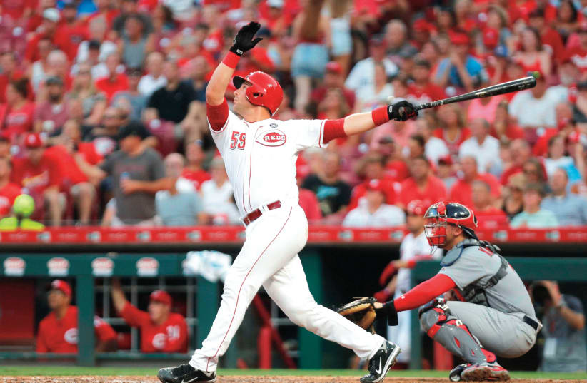 FORMER TEAM ISRAEL catcher Ryan Lavarnwaycrushes one of the two home runs he hit in his Cincinnati Reds debut last month, his first of five games with the MLB club before being sent back to the minors. (photo credit: REUTERS)