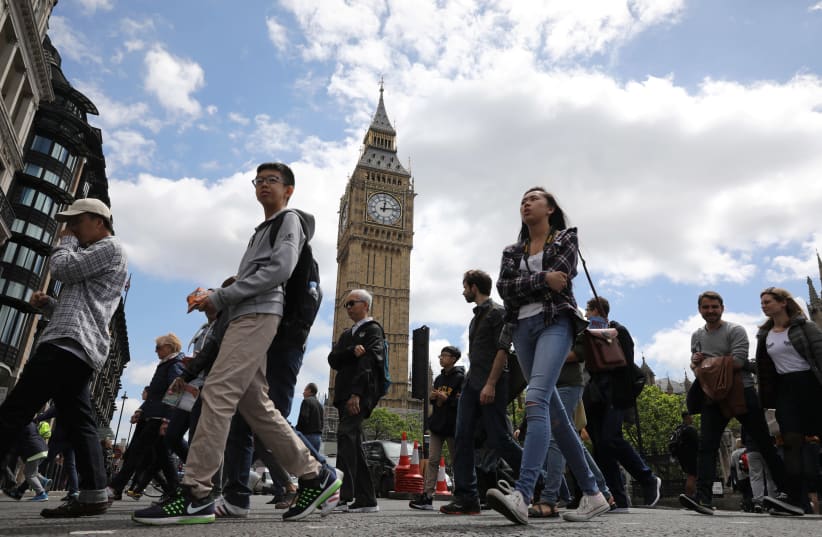 Tourists walk past Big Ben in Westminster (photo credit: MARKO DJURICA / REUTERS)