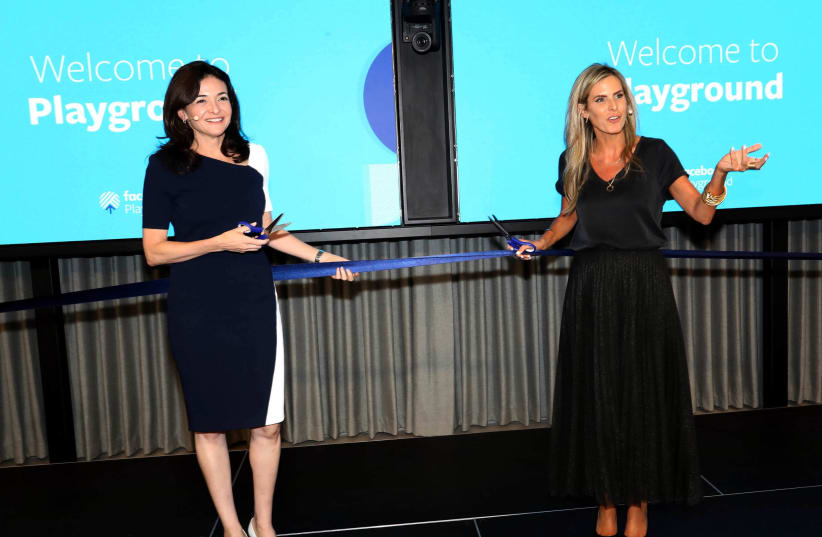 Facebook COO Sheryl Sandberg (L) and Facebook Israel general manager Adi Soffer Teeni (R) inaugurate the company's Tel Aviv "Playground," August 14, 2019 (photo credit: SIVAN FARAG)