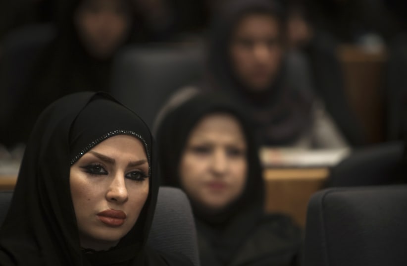 An Iranian hairstylist looks on as she attends a ceremony to mark the national Chastity and Hijab day at a conference centre in Tehran (photo credit: REUTERS)