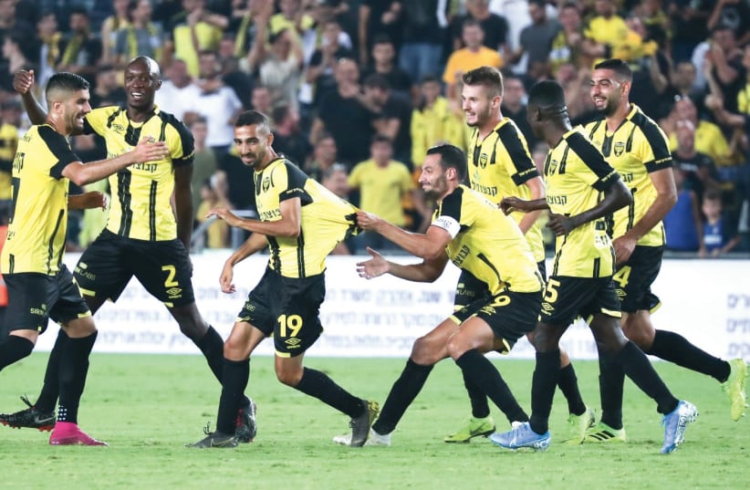 BEITAR JERUSALEM players celebrate during their 3-1 victory over Hapoel Beersheba in Sunday night’s Toto Cup semifinal at Teddy Stadium in the capital. (photo credit: DANNY MARON)