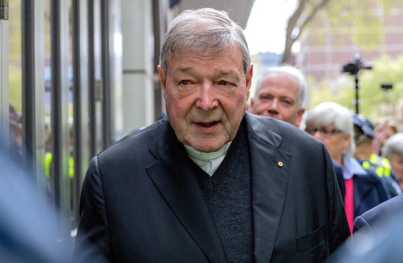 Vatican Treasurer Cardinal George Pell is surrounded by Australian police as he leaves the Melbourne Magistrates Court in Australia, October 6, 2017 (photo credit: REUTERS/MARK DADSWELL)