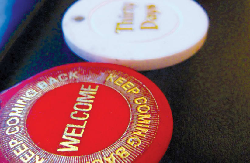SOBRIETY COINS given to Alcoholics Anonymous members representing the amount of time they have remained sober. (photo credit: CHRIS YARZAB/FLICKR)