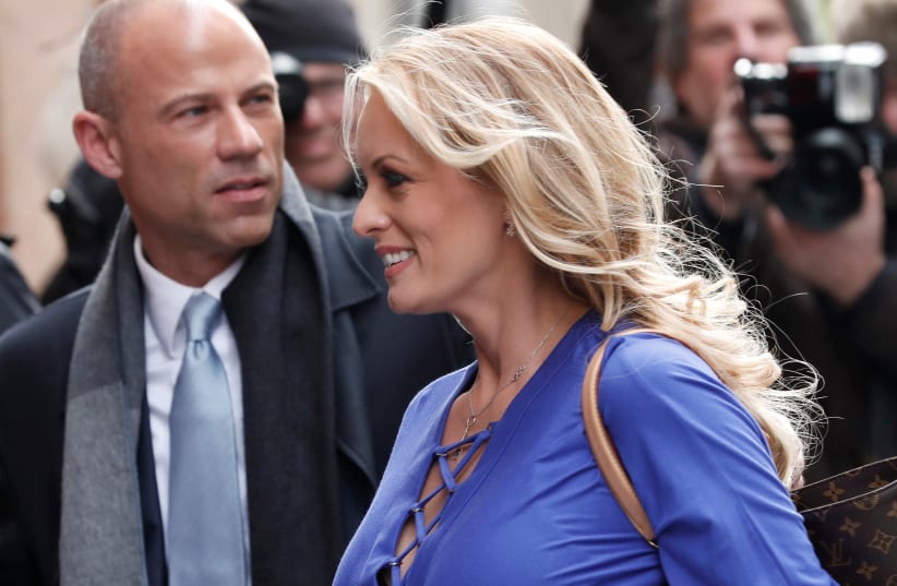 Adult-film actress Stephanie Clifford, also known as Stormy Daniels, arrives with her attorney Michael Avenatti (L) at ABC studios to appear on The View talk show in New York City, New York, U.S. (photo credit: REUTERS/MIKE SEGAR)