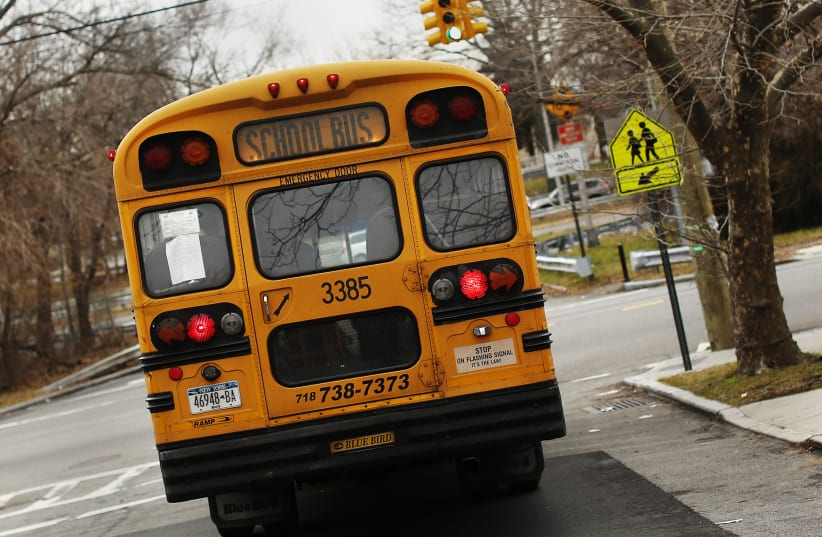 A school bus used for transporting New York City public school students is seen driving down 135th avenue in the Queens borough of New York  (photo credit: REUTERS/SHANNON STAPLETON)