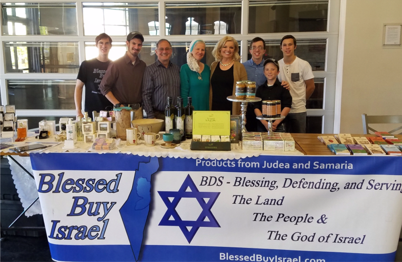 The Wearp family showcase some of the products from Judea and Samaria that they export and sell in the United States as part of their Blessed Buy Israel venture. (photo credit: ILANIT CHERNICK)