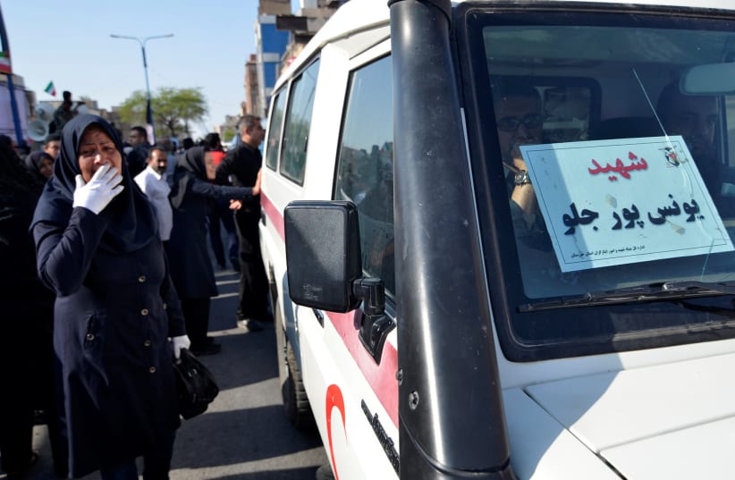 Ambulance is seen during a funeral of the victims of assault that killed 25 people, in the streets of the southwestern Iranian city of Ahvaz (photo credit: REUTERS/TASNIM NEWS AGENCY)
