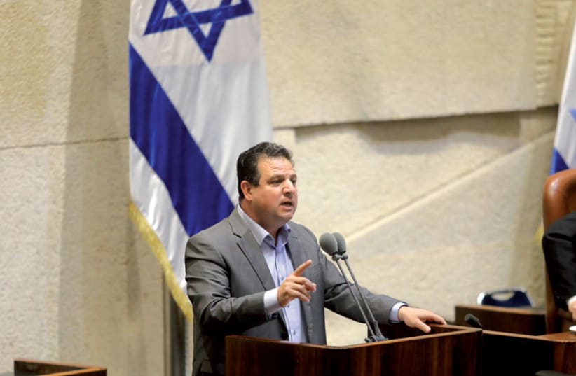 Joint List leader Ayman Odeh addresses the Knesset: Odeh has suggested, for the first time, that Israeli Arabs would be willing to join a government coalition (photo credit: MARC ISRAEL SELLEM)