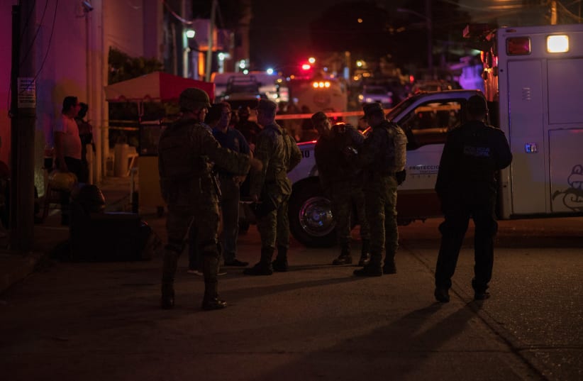 Soldiers gather near a crime scene following a deadly attack at a bar by unknown assailants in Coatzacoalcos, Mexico August 28, 2019. (photo credit: REUTERS/ANGEL HERNANDEZ)