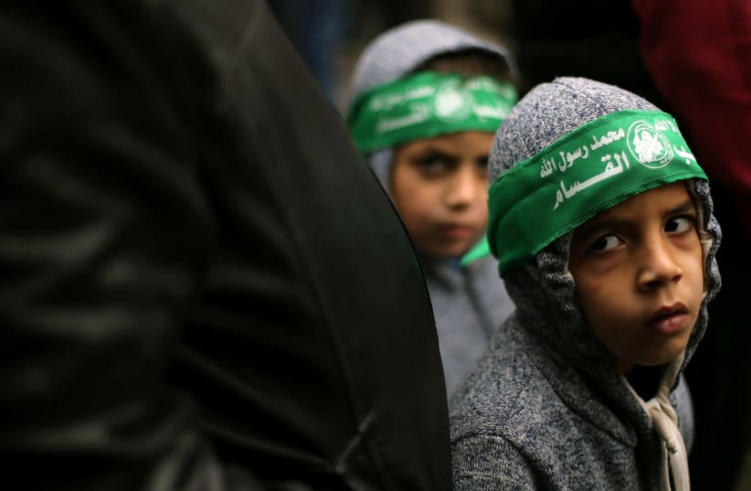 Palestinian children wearing Hamas headbands take part in a rally against U.S. President Donald Trump's decision to recognize Jerusalem as the capital of Israel, in the Gaza Strip (photo credit: IBRAHEEM ABU MUSTAFA/REUTERS)