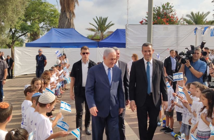 Prime Minister Benjamin Netanyahu with Elkana municipality head Asaf Mintser for the beginning of the new school year along with first-grade students. (photo credit: Courtesy)