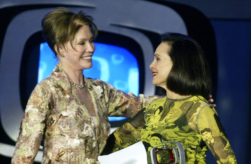 Actress Mary Tyler Moore (L) greets co-star actress Valerie Harper as they accept the Ground Breaking Show award for their series "The Mary Tyler Moore Show" during a taping of the second annual TV Land Awards in Hollywood March 7, 2004 (photo credit: REUTERS)