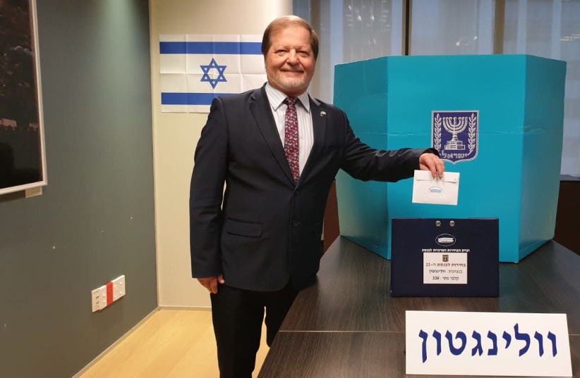 Israeli Ambassador to New Zealand, Dr. Itzhak Greenberg, casts the first vote in the Israeli Elections on Thursday morning in the Israeli embassy in Wellington (photo credit: MFA)