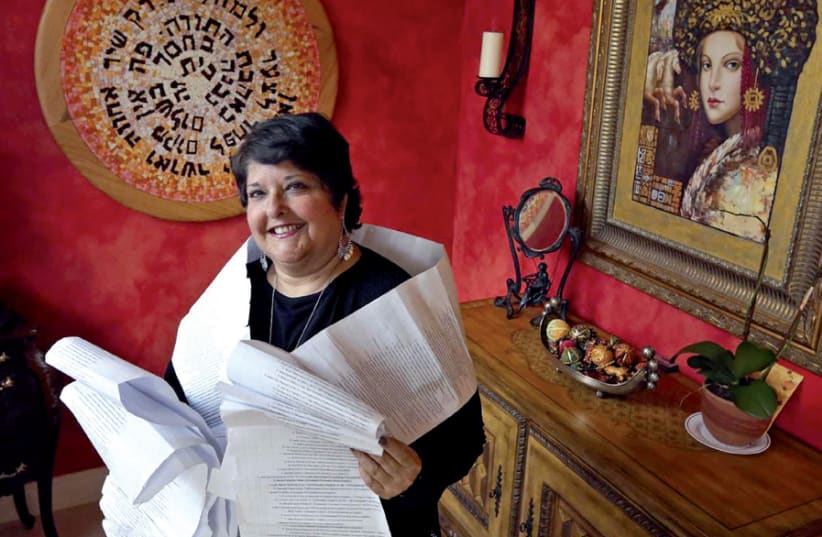Genie Milgrom is draped with a printout filled with the names of 22 generations of her mother’s maternal line (photo credit: EMILY MICHOT / MCCLATCHY-TRIBUNE NEWS SERVICE)