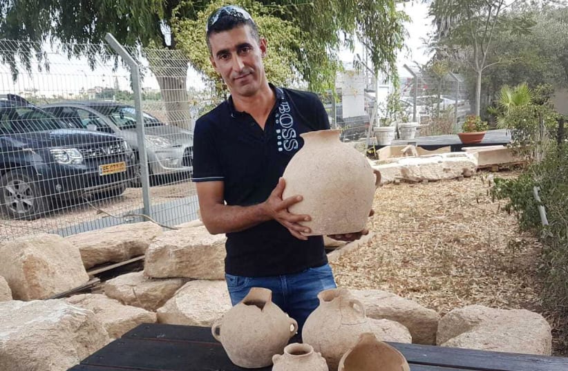 Yassin with Middle Bronze age vessels (photo credit: Israel Antiquities Authority)
