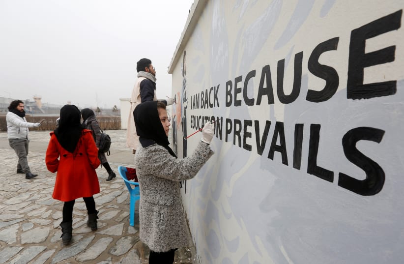 Afghan Artlords paint a message on a wall at the American University of Afghanistan in Kabul (photo credit: REUTERS)
