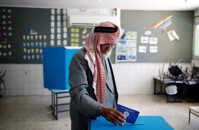 A Bedouin man casts his ballot in Knesset elections on April 9, 2019 (photo credit: AMIR COHEN/REUTERS)