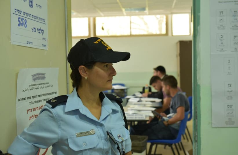 A police officer in a polling station (photo credit: POLICE SPOKESPERSON'S UNIT)