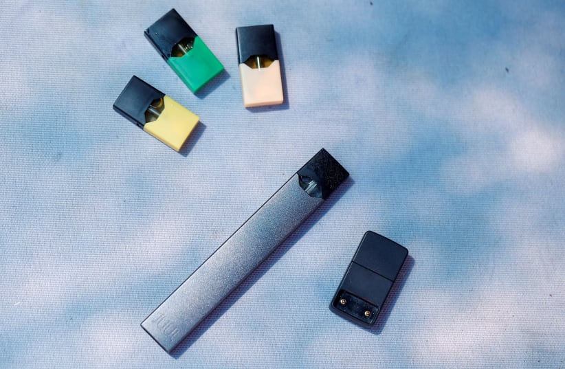 A Juul e-cigarette and pods are seen in this picture illustration taken September 16, 2018 (photo credit: REUTERS/Ronen Zvulun)