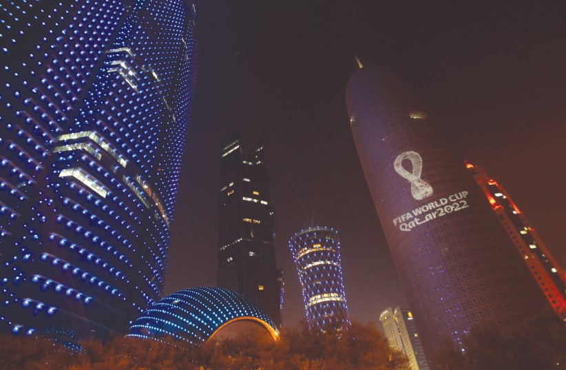 The logo for the 2022 Qatar World Cup displayed on Doha Tower   (photo credit: NASEEM ZEITOON/REUTERS)