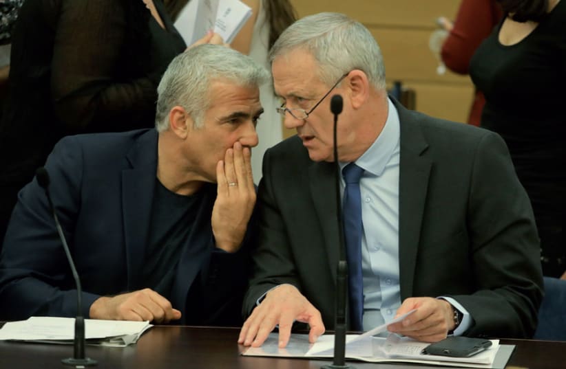 Blue and White leaders Benny Gantz and Yair Lapid confer at a party meeting (photo credit: MARC ISRAEL SELLEM)