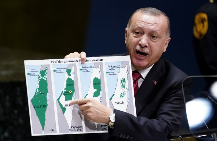 Turkey's President Recep Tayyip Erdogan holds up a map as he addresses the 74th session of the United Nations General Assembly at U.N. headquarters in New York City, New York, U.S., September 24, 2019 (photo credit: REUTERS/CARLO ALLEGRI)