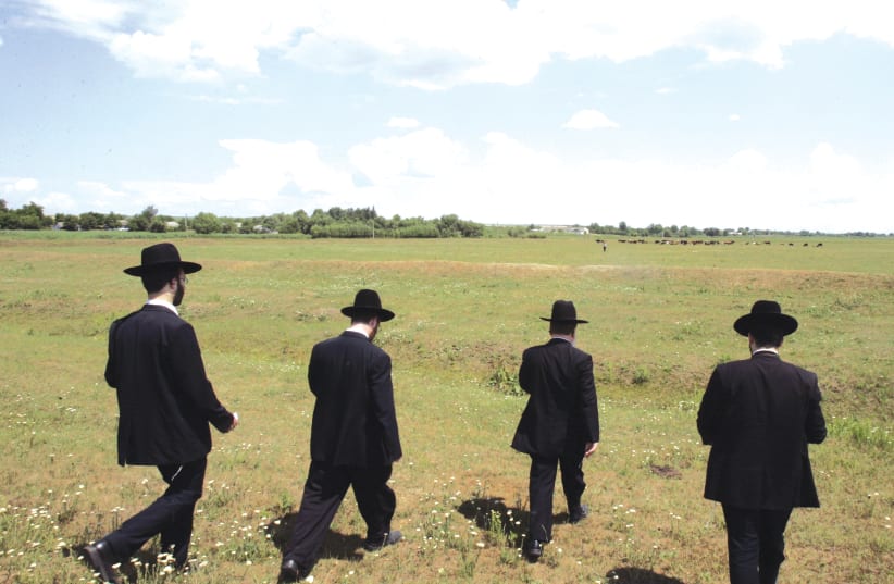Jewish Hassidic men walking in Eastern Europe   (photo credit: REUTERS)