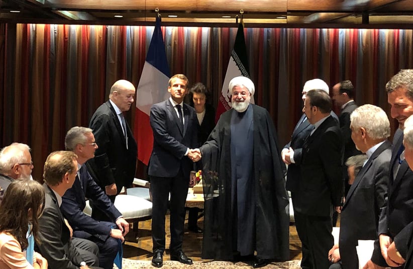 French President Emmanuel Macron shakes hands with Iranian President Hassan Rouhani during their meeting on the sidelines of the United Nations General Assembly in New York, U.S., September 23, 2019.  (photo credit: REUTERS/JOHN IRISH)