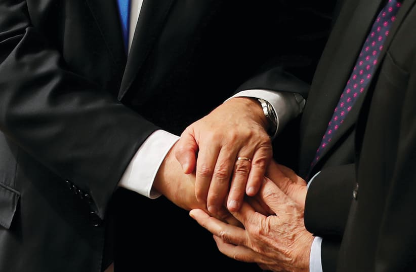 Netanyahu, Rivlin and Gantz holding hands  (photo credit: RONEN ZVULUN / REUTERS)