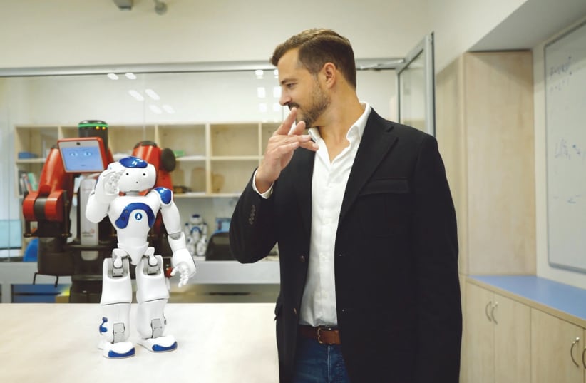 AI ROBOT Nao teaches ‘TechTalk’ host and executive producer Jonny Caplan how to do Tai Chi in the Curios Robots Lab at Tel Aviv University (photo credit: Courtesy)