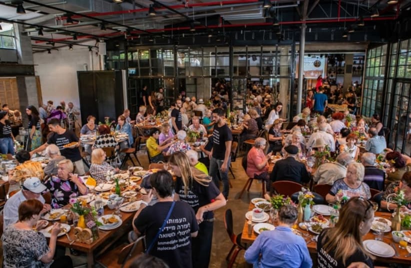 Survivors and guests eat together at the Rosh Hashanah event organized by the Association for Immediate Help for Holocaust Survivors (photo credit: GAL HAIM)
