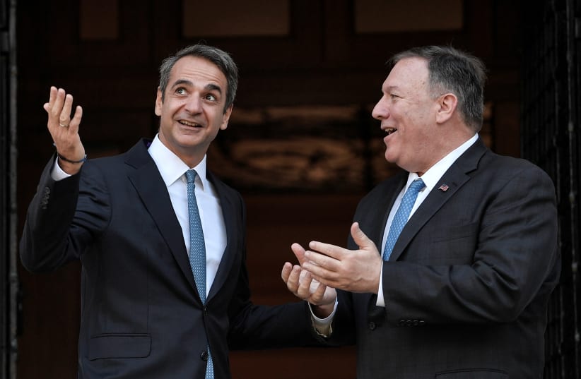 U.S. Secretary of State Mike Pompeo is welcomed by Greek Prime Minister Kyriakos Mitsotakis at the Maximos Mansion in Athens, Greece, October 5, 2019 (photo credit: LOUISA GOULIAMAKI/POOL VIA REUTERS)