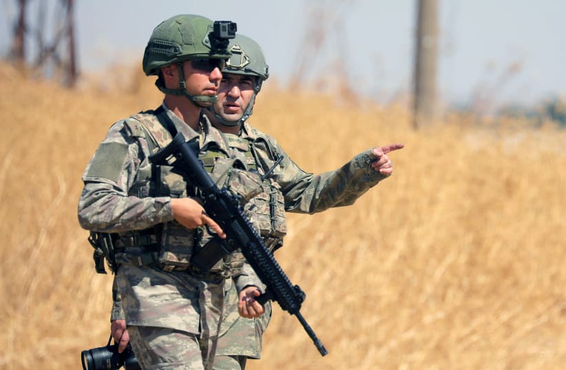 Turkish soldiers walk together during a joint U.S.-Turkey patrol, near Tel Abyad, Syria (photo credit: REUTERS/RODI SAID)