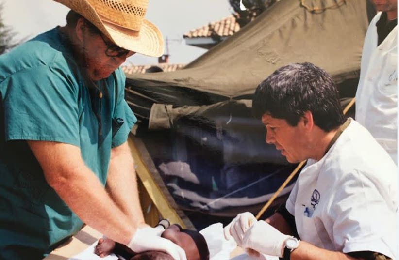 PROF. NATI KELLER working at a field hospital in Rwanda in the early 1990s.   (photo credit: ALMOG’S PERSONAL COLLECTIONS.)