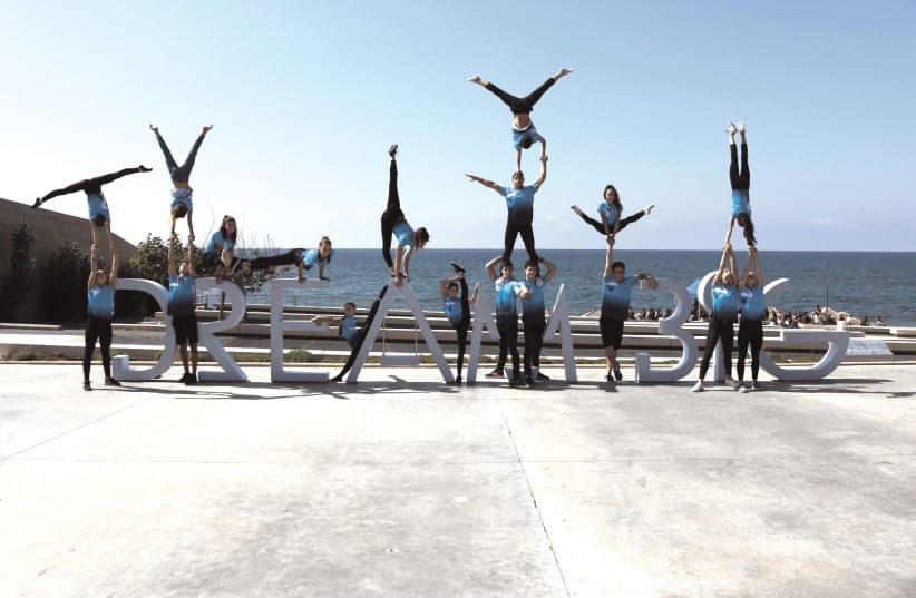 The ISRAEL acrobatics team visited the Peres Center for Peace this week and posed on the ‘Dream Big’ installation ahead of the European Acrobatic Gymnastics Championships, to be held in Holon later this month (photo credit: CHEN SHINAV)