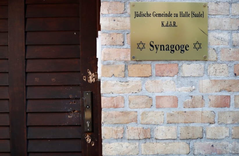 The damaged door of a synagogue is seen in Halle, Germany October 10, 2019, after two people were killed in a shooting (photo credit: REUTERS/FABRIZIO BENSCH)