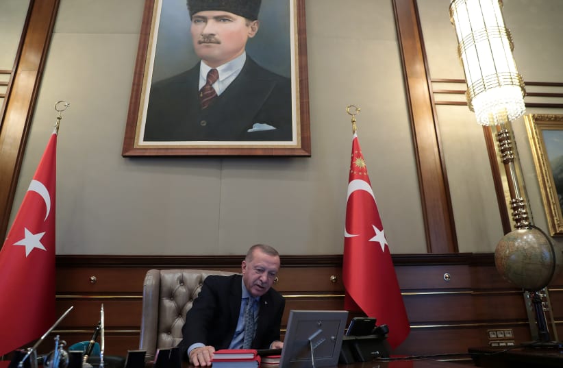 Turkish President Tayyip Erdogan speaks to Defence Minister Hulusi Akar on the phone at the Presidential Palace in Ankara, Turkey, October 9, 2019 (photo credit: REUTERS)