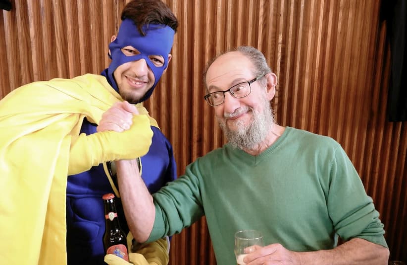 THE WRITER arm-wrestles with the SMASH superhero over the new Six-Pack IPA.  (photo credit: MIKE HORTON)