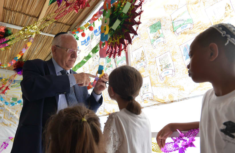 President Rivlin decorating his Sukkah (photo credit: KOBY GIDEON/GPO)
