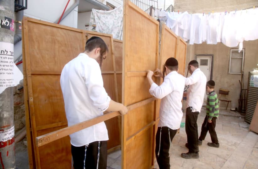 Constructng a Sukkah in Meah Shearim (photo credit: Courtesy)