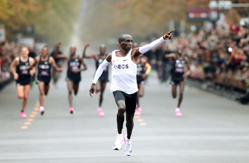 Kenya's Eliud Kipchoge, the marathon world record holder, crosses the finish line during his attempt to run a marathon in under two hours in Vienna, Austria, October 12, 2019 (photo credit: REUTERS/LISI NIESNER)