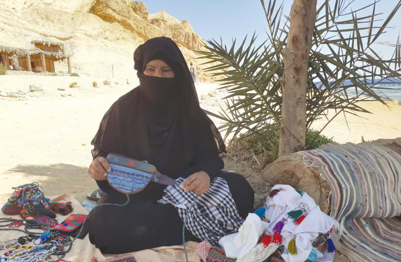 A BEDOUIN woman displays some of her wares (photo credit: GIL ZOHAR)