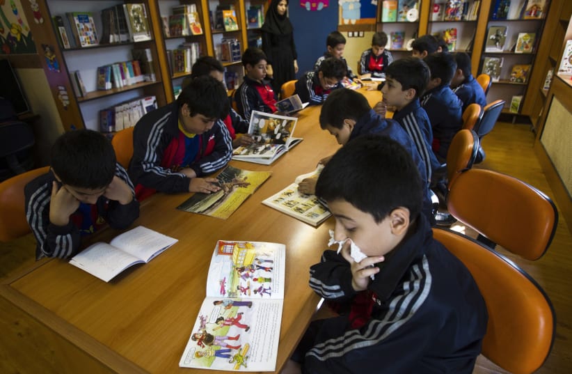 Students read in the library at Pishtaz School in Tehran (photo credit: RAHEB HOMAVANDI/REUTERS)