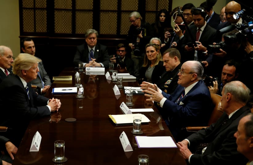 U.S. President Donald Trump listens to former New York City Mayor Rudy Giuliani during a meeting with cyber security experts in the Roosevelt Room of the White House in Washington, U.S., January 31, 2017.  (photo credit: REUTERS/KEVIN LAMARQUE)