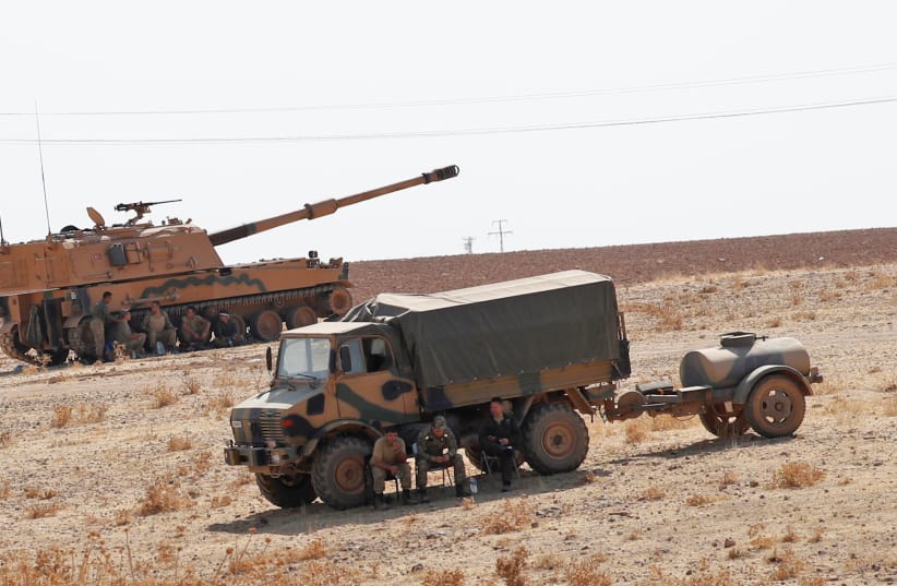 Turkish army vehicles and military personnel are stationed near the Turkish-Syrian border in Sanliurfa province, Turkey, October 12, 2019 (photo credit: MURAD SEZER/REUTERS)