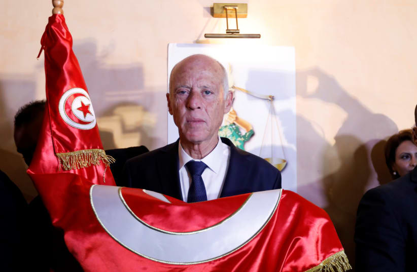Tunisian presidential candidate Kais Saied reacts after exit poll results were announced in a second round runoff of the presidential election in Tunis, Tunisia October 13, 2019 (photo credit: REUTERS/ZOUBEIR SOUISSI)