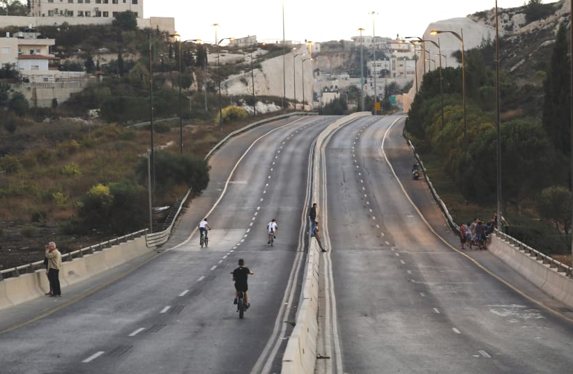 People riding their bikes in Jerusalem during Yom Kippur (photo credit: AMMAR AWAD / REUTERS)