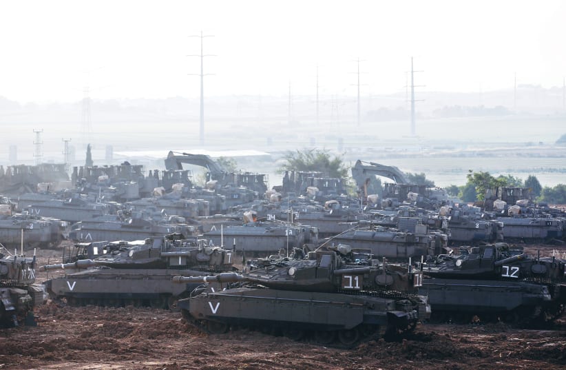 IDF tanks, armored personnel carriers (APC) and other armored vehicles gather near the border with Gaza in May (photo credit: REUTERS/Ronen Zvulun)