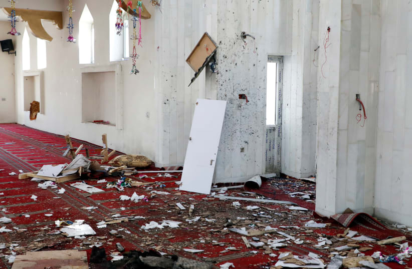 Hats are seen inside a mosque after a blast in Kabul (photo credit: OMAR SOBHANI / REUTERS)